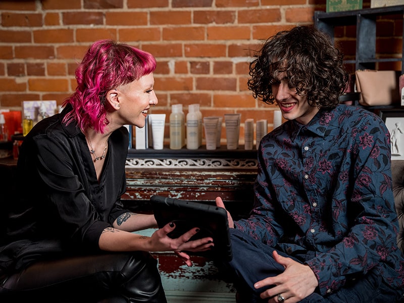 a man and a woman sitting on a bench